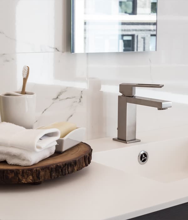 A bathroom sink with a neatly folded towel placed on the counter beside it.